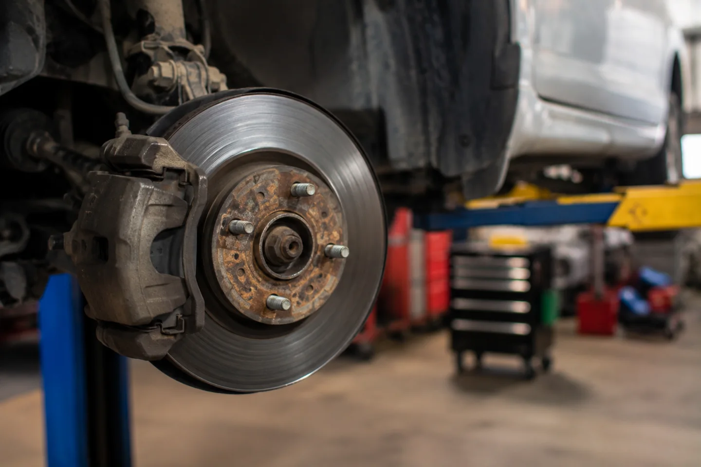 Exposed brake rotor and caliper with the wheel removed.