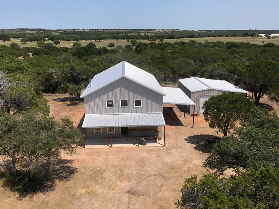 Custom barndominium exterior with steel panels at Texas ranch property